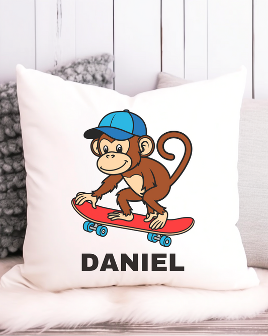 Kids cushion cover with cartoon monkey riding a red skateboard wearing a blue cap, with custom name.