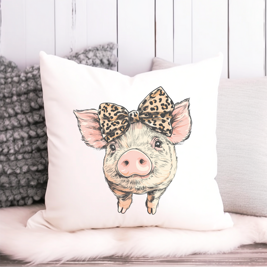 Cute pig cushion cover with a leopard print bow on a white background – 40x40cm canvas-style throw pillow, styled on a fluffy seat