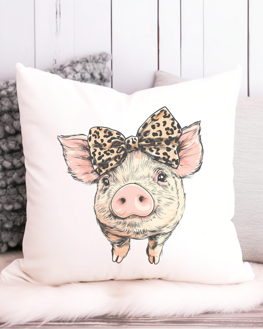 Cute pig cushion cover with a leopard print bow on a white background – 40x40cm canvas-style throw pillow, styled on a fluffy seat