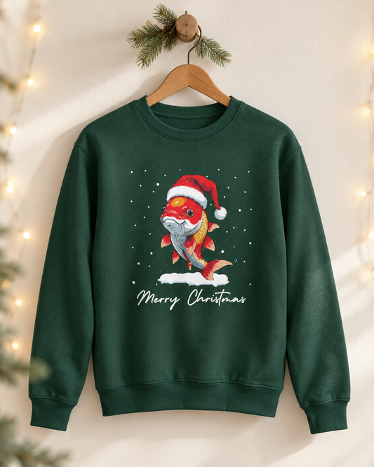 Dark green adult Christmas crewneck jumper hanging on a wooden hanger, featuring an orange and white koi carp wearing a Santa hat with falling snow and Merry Christmas printed below.