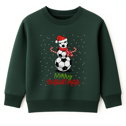 Kids dark green Christmas sweatshirt featuring a festive snowman made of stacked footballs wearing a red Santa hat and scarf, candy cane arms, with falling snow and the text “Merry Christmas” in red and green beneath.