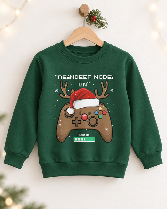 Children’s dark-green festive gamer sweatshirt on a wooden hanger with holly and warm fairy lights.