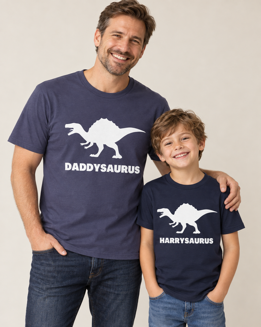 Father and son wearing navy Daddysaurus and personalised Harrysaurus dinosaur T-shirts