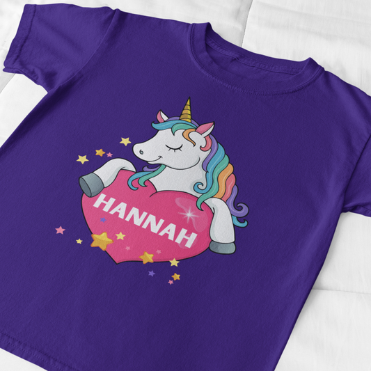 Close view of girls purple unicorn heart T-shirt, pastel kids top with magical unicorn design.