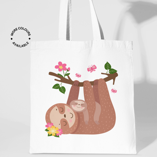 Kids white cotton tote bag featuring a cute mother and baby sloth illustration, hanging from a floral tree branch with butterflies.