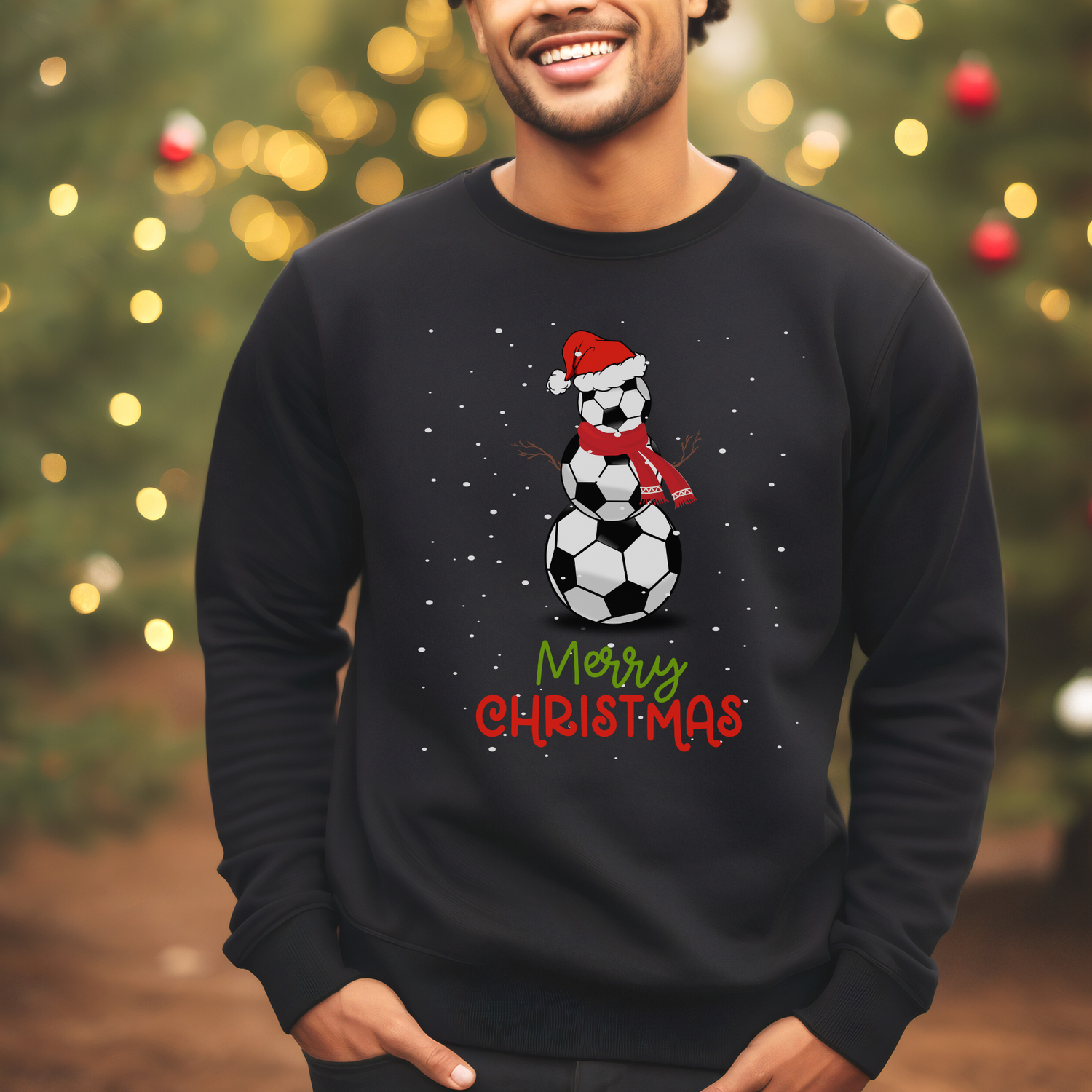 Man wearing a black christmas sweatshirt with a printed design of a football snowman and words saying "merry christmas"