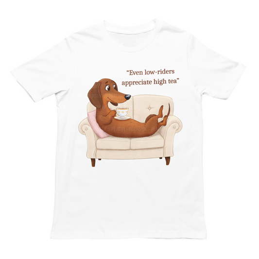 Women's white t-shirt featuring an Illustrated dachshund reclining on a sofa, sipping tea, with the caption "Even low-riders appreciate high tea."
