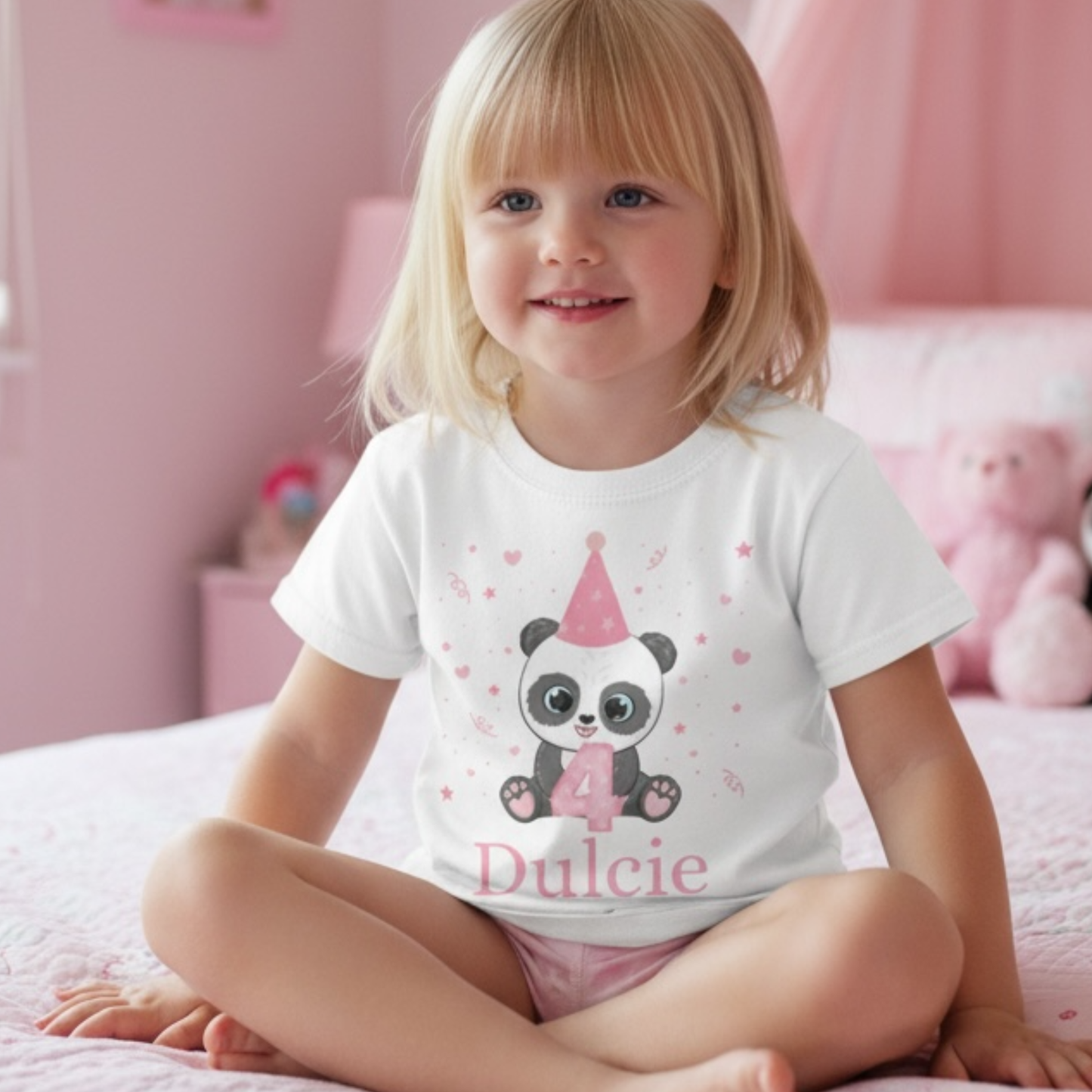 Little girl wears 4th birthday panda t-shirt in a pink bedroom.