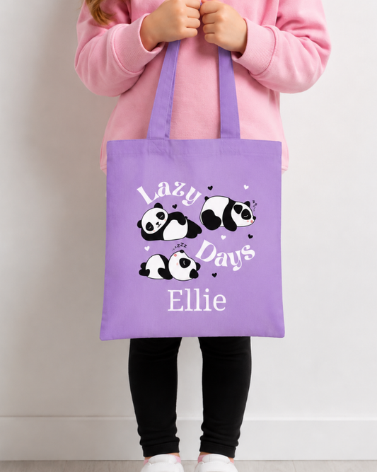 Girl holding purple kids panda tote bag in lavender colour with personalised Lazy Days sleeping panda print