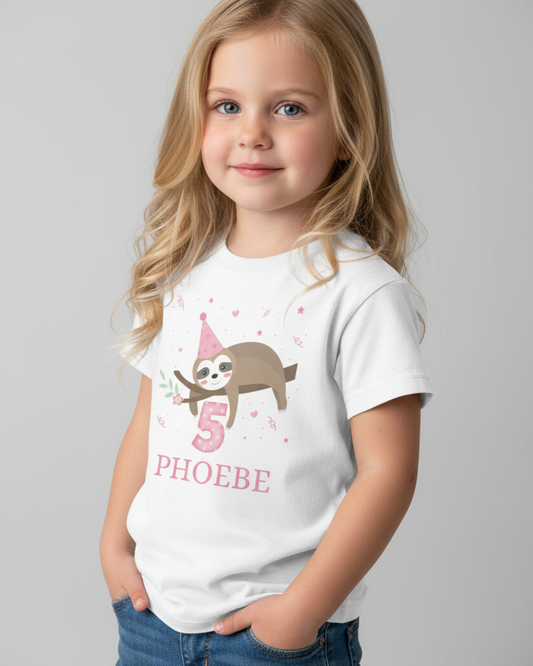 Child wearing custom 5th birthday sloth t-shirt in white, featuring pink number 5 and name PHOEBE, studio portrait.