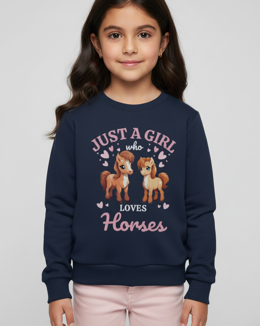 Young girl wearing a navy blue sweatshirt with horse-themed design on a plain background