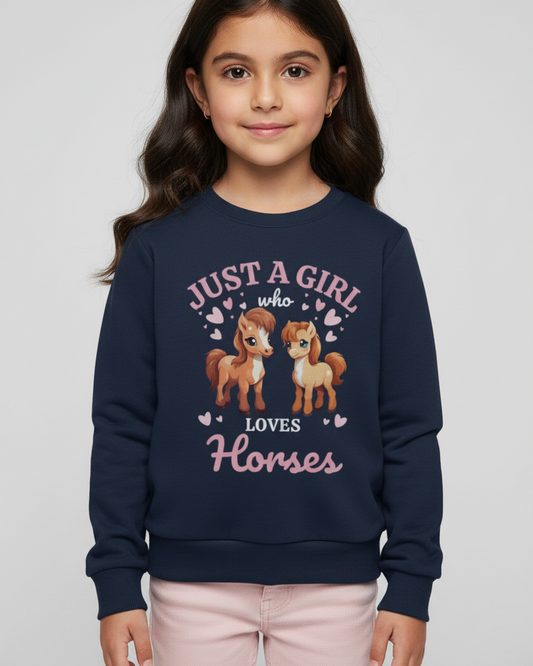 Young girl wearing a navy blue sweatshirt with horse-themed design on a plain background