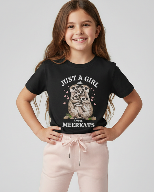 Happy young girl modelling a black meerkat graphic t-shirt with pink joggers in a bright studio setting