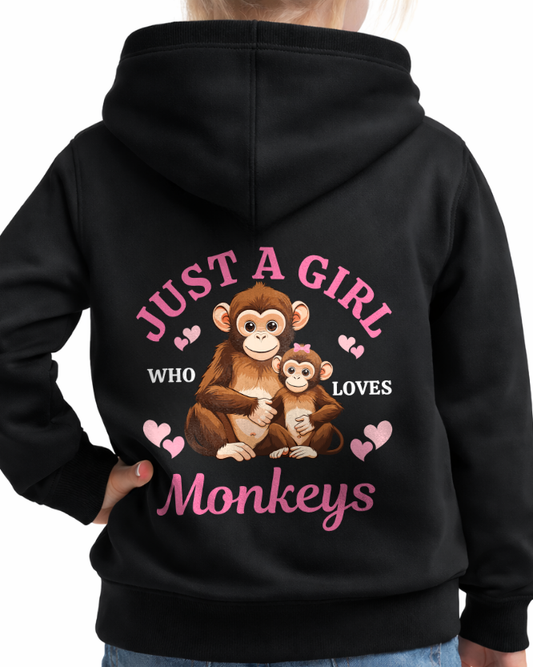 Child models a black zip up hoodie with a cute monkey design printed on the back.