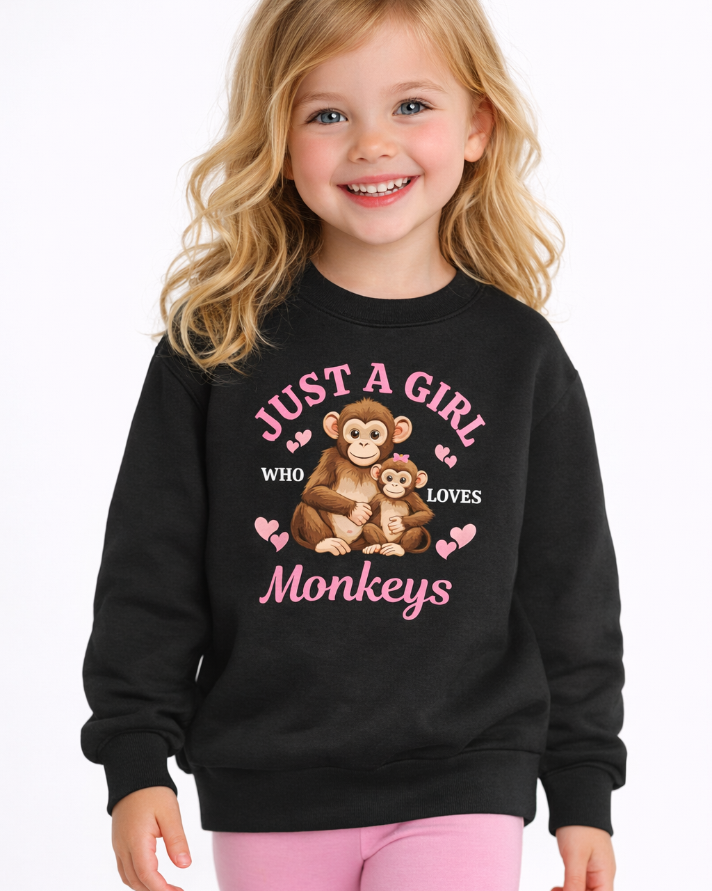 Young girl smiling wearing black monkey graphic sweatshirt “Just a Girl Who Loves Monkeys” kids jumper with pink leggings