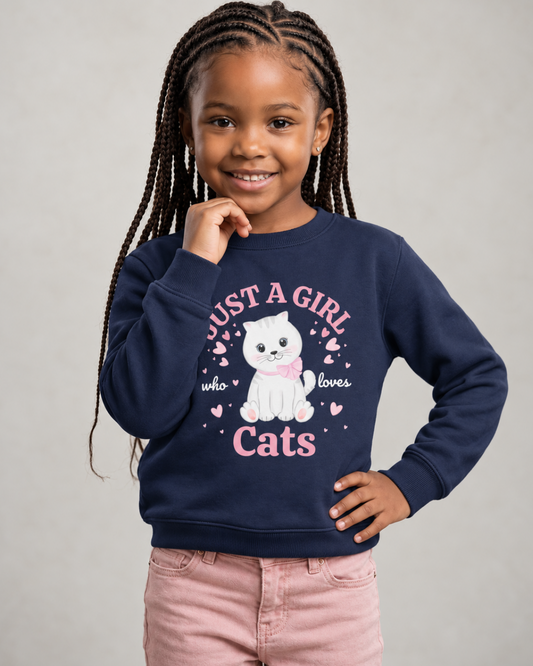 Girl wearing a navy “Just a Girl Who Loves Cats” sweatshirt featuring a white kitten with a pink bow and surrounding hearts, paired with pink jeans.