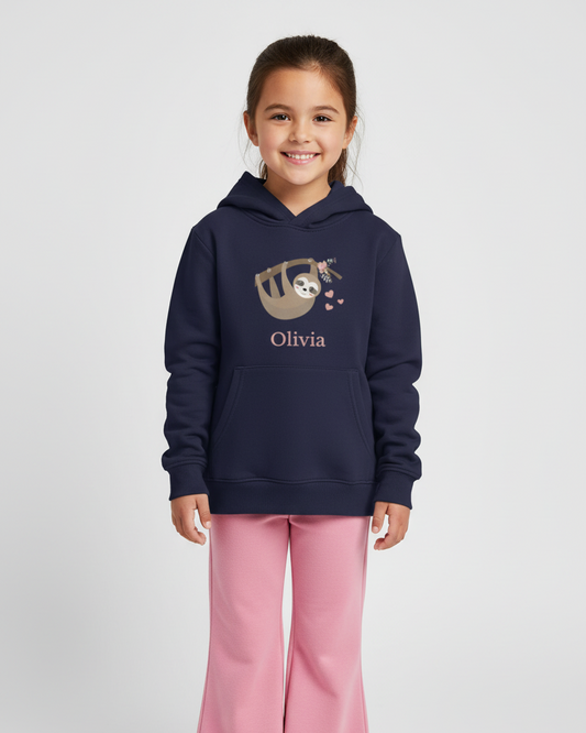 Young girl modelling a navy custom name hoodie featuring a sweet sloth illustration and the name Olivia, full length view on a light studio background