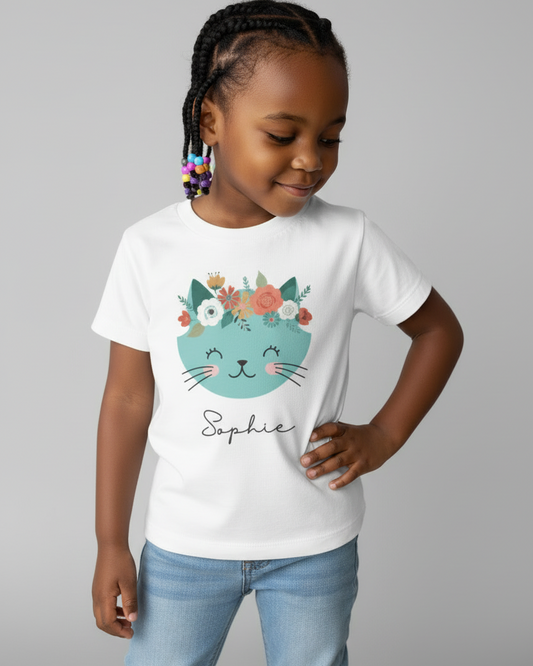 Young girl modelling white custom name cat t-shirt with floral headpiece design, studio background