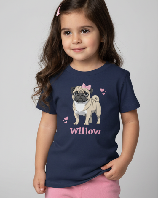 Young girl wearing a navy personalised pug t-shirt with pink bow dog illustration and the name Willow, studio background