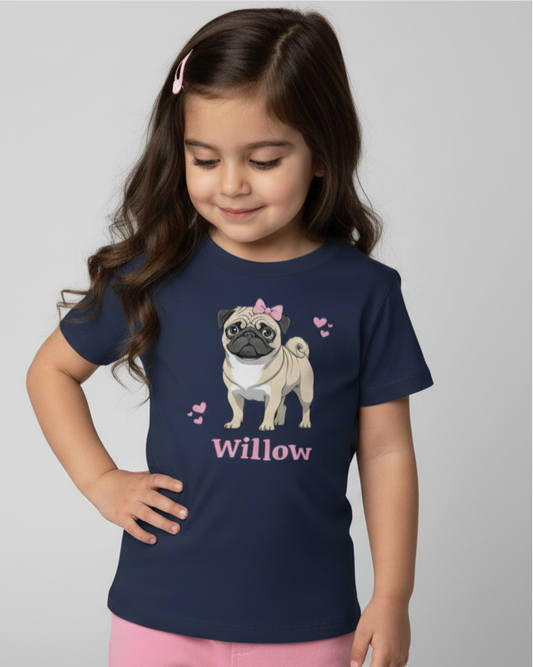 Child modelling navy custom name pug t-shirt with cute dog graphic and pink hearts, studio portrait