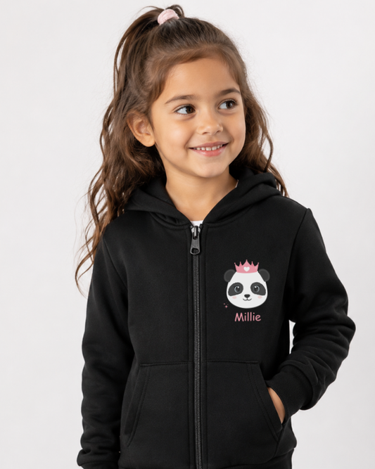 Young girl wearing a black hoodie with a panda design and text on a white background