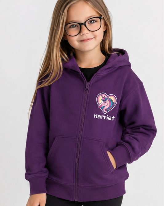 Purple personalised unicorn heart zip hoodie on smiling girl model with black leggings in bright studio setting
