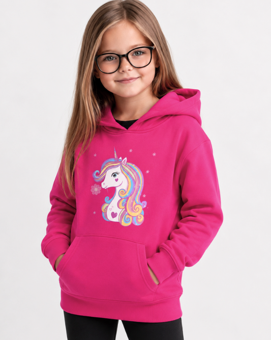 Girl wearing hot pink unicorn hoodie with black leggings in bright studio