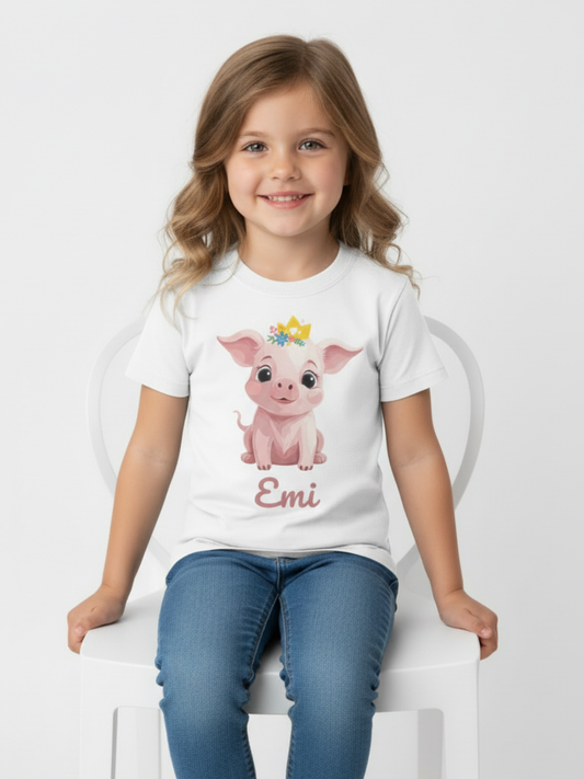 Child modelling personalised princess pig shirt with custom name on white kids t-shirt sitting on chair