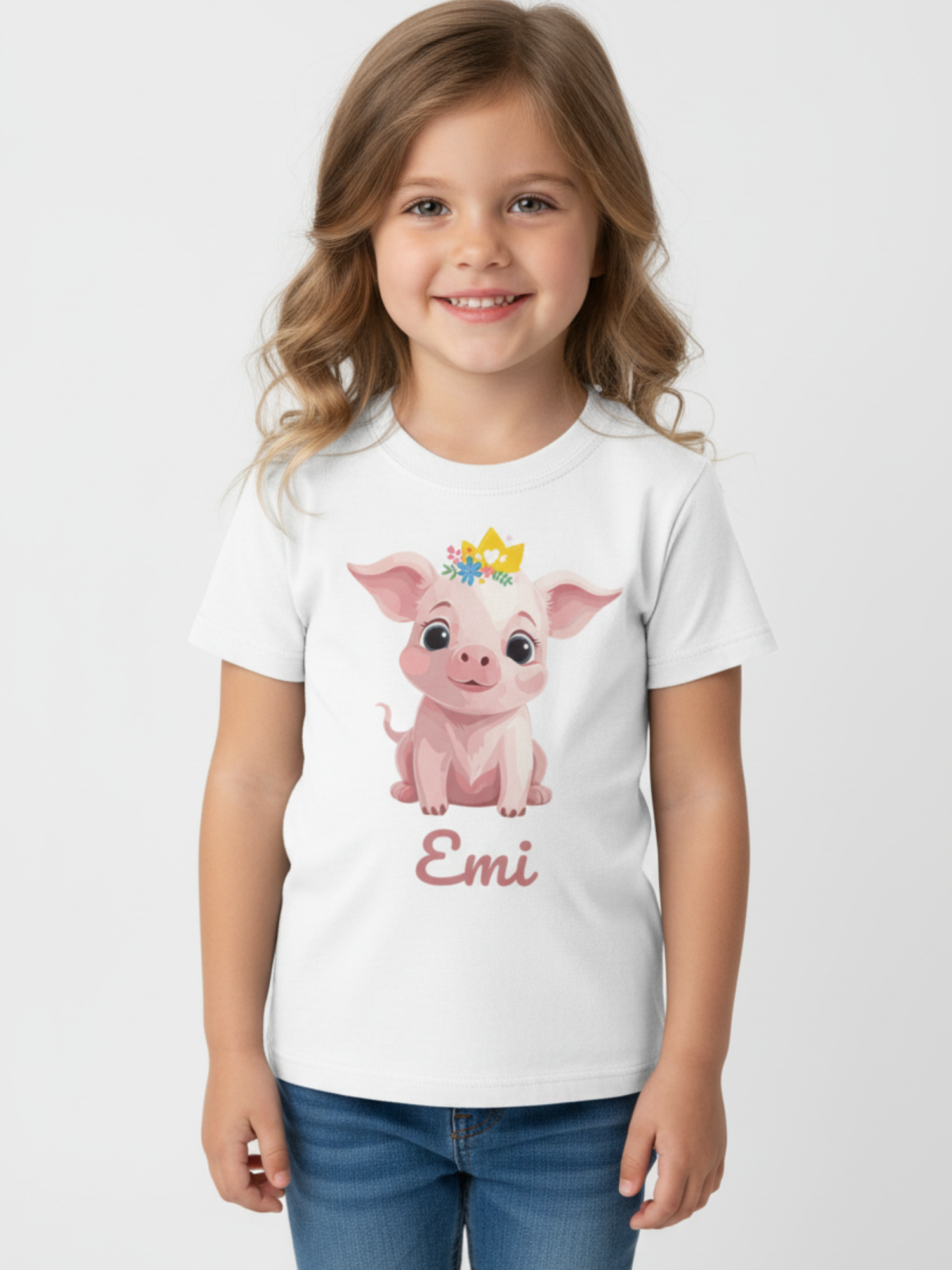 Personalised girls princess pig t-shirt with custom name Emi worn by smiling young girl on white background