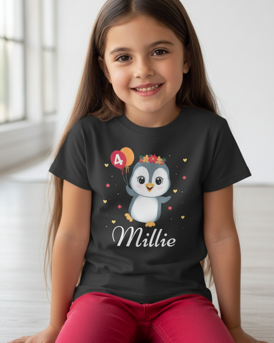 Close-up of personalised penguin birthday t-shirt for girls with custom name Millie and age 4 balloon