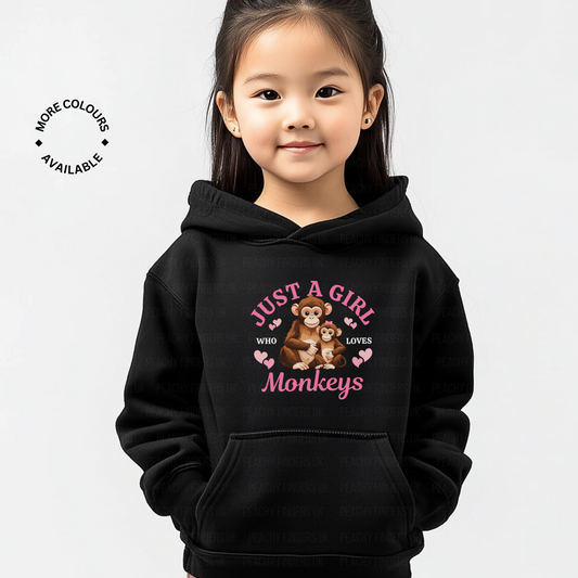 Child wearing a black hoodie with monkey design and text on a white background