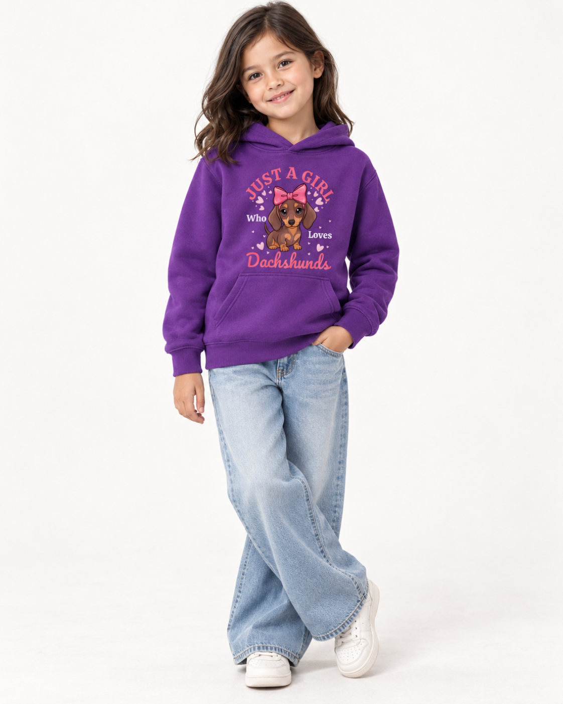 Girl wearing a purple hoodie featuring a dachshund puppy with a pink bow, hearts and “Just a Girl Who Loves Dachshunds” wording.