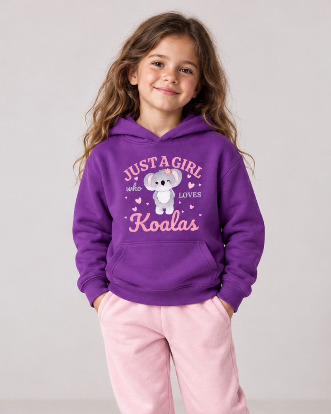 7-year-old girl wearing a purple Just a Girl Who Loves Koalas hoodie with light-pink joggers.