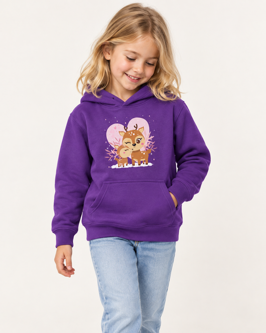 Young girl wearing a purple hoodie with a mother and baby reindeer design, styled with light-wash jeans in a bright studio.