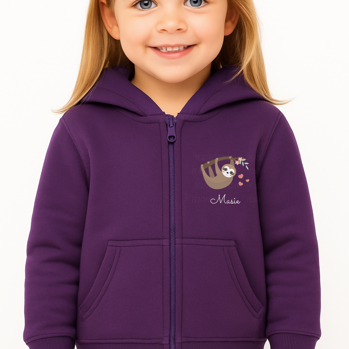 Little girl modelling a purple zip-up hoodie with hanging sloth, floral branch, pink hearts, and personalised name printed on the chest.