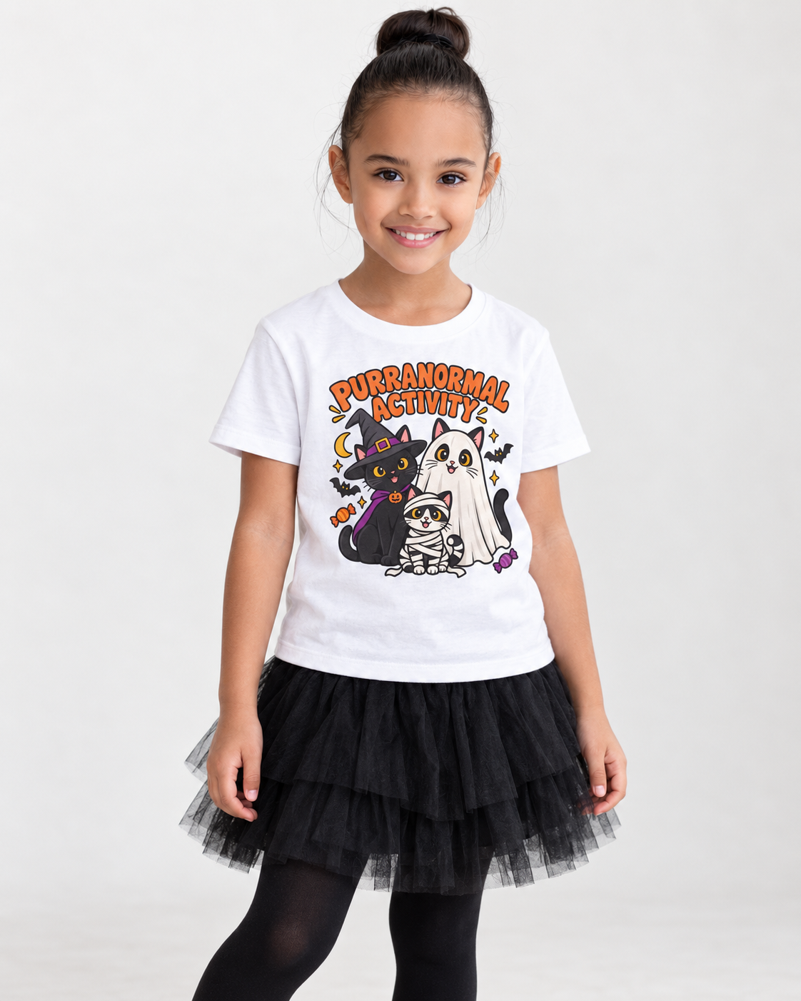 Girl wearing a white 'Purranormal Activity' Halloween T-shirt featuring witch, ghost and mummy cats