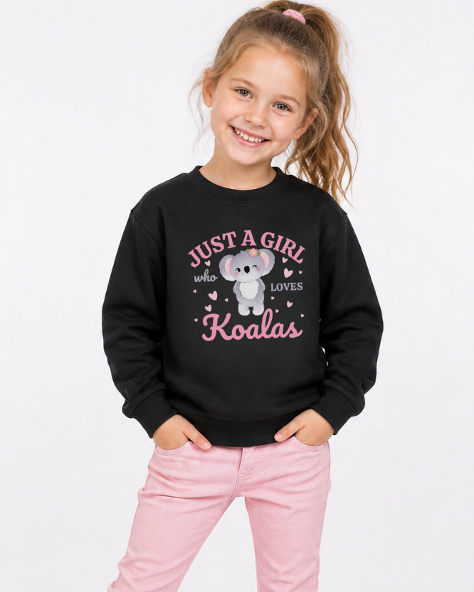 Girls black “just a girl who loves koalas” sweatshirt with cute koala graphic, worn by child with pink jeans, kids animal lover jumper UK