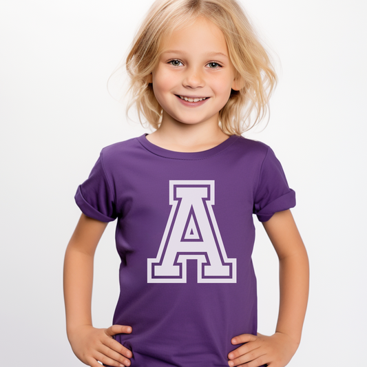 Little girl wearing a purple short sleeve t-shirt with a large initial 