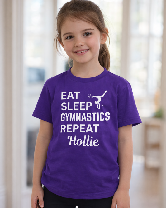 Girl wearing purple personalised “Eat Sleep Gymnastics Repeat” t-shirt with custom name Hollie, kids gymnastics shirt front view