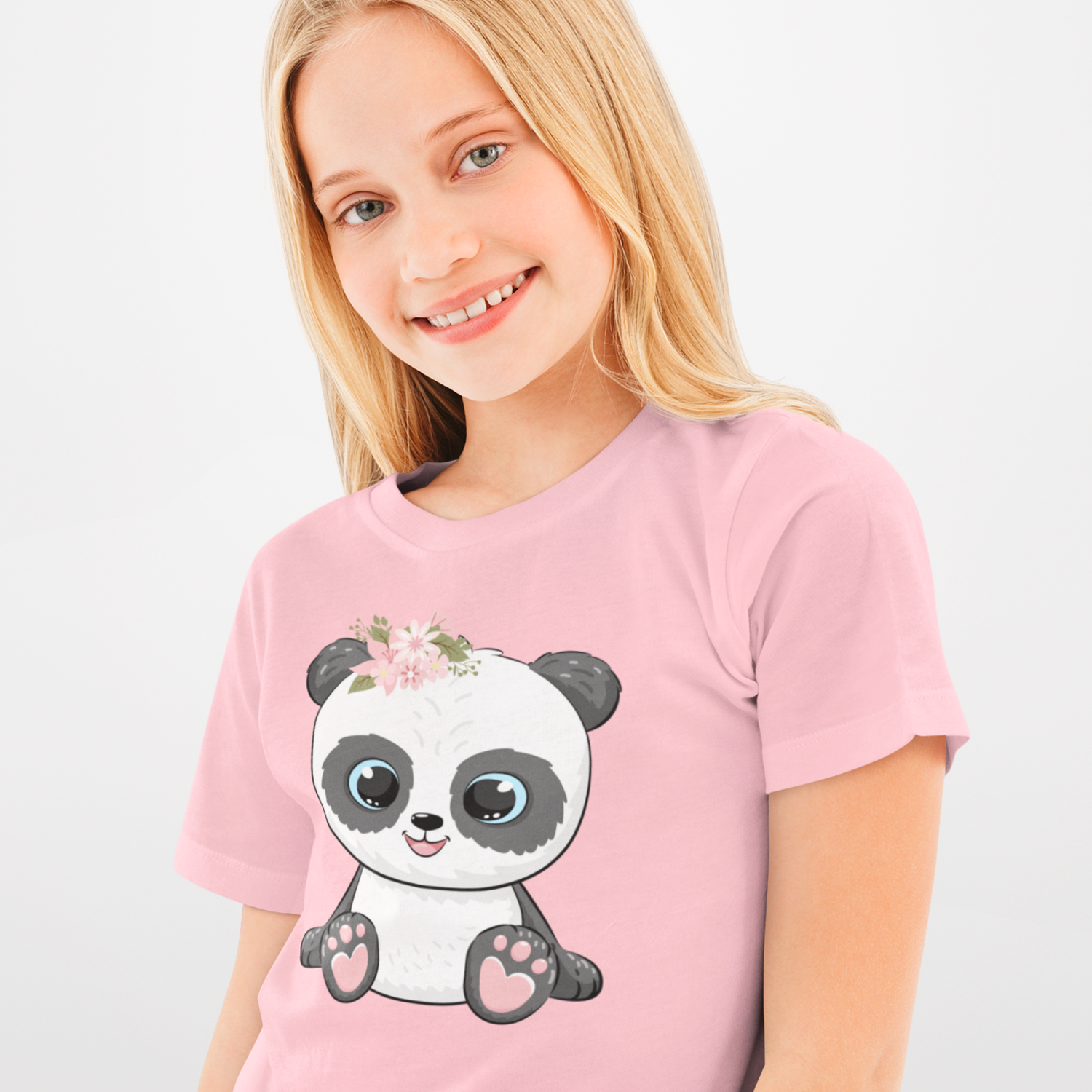 Girl wears pink organic cotton t-shirt featuring a cute panda illustration with big blue eyes and a floral crown