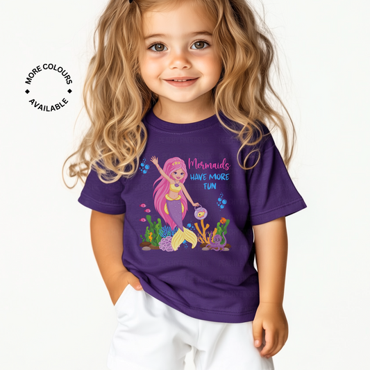 Little girls wears purple T-shirt featuring a colourful mermaid design and the phrase “Mermaids Have More Fun,” surrounded by sea creatures and coral.