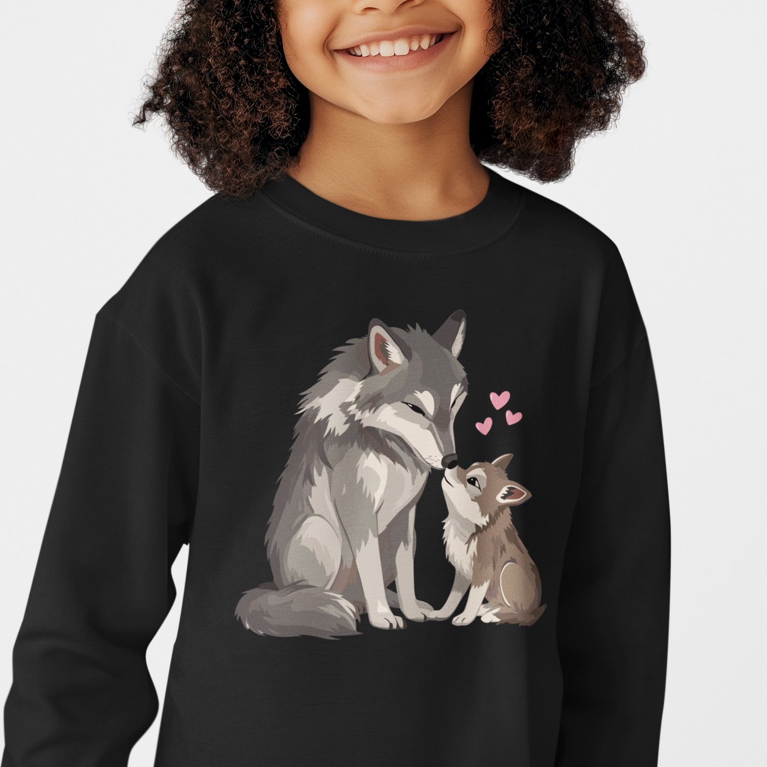 Child wearing a black sweatshirt with a wolf and wolf cub design on a white background.