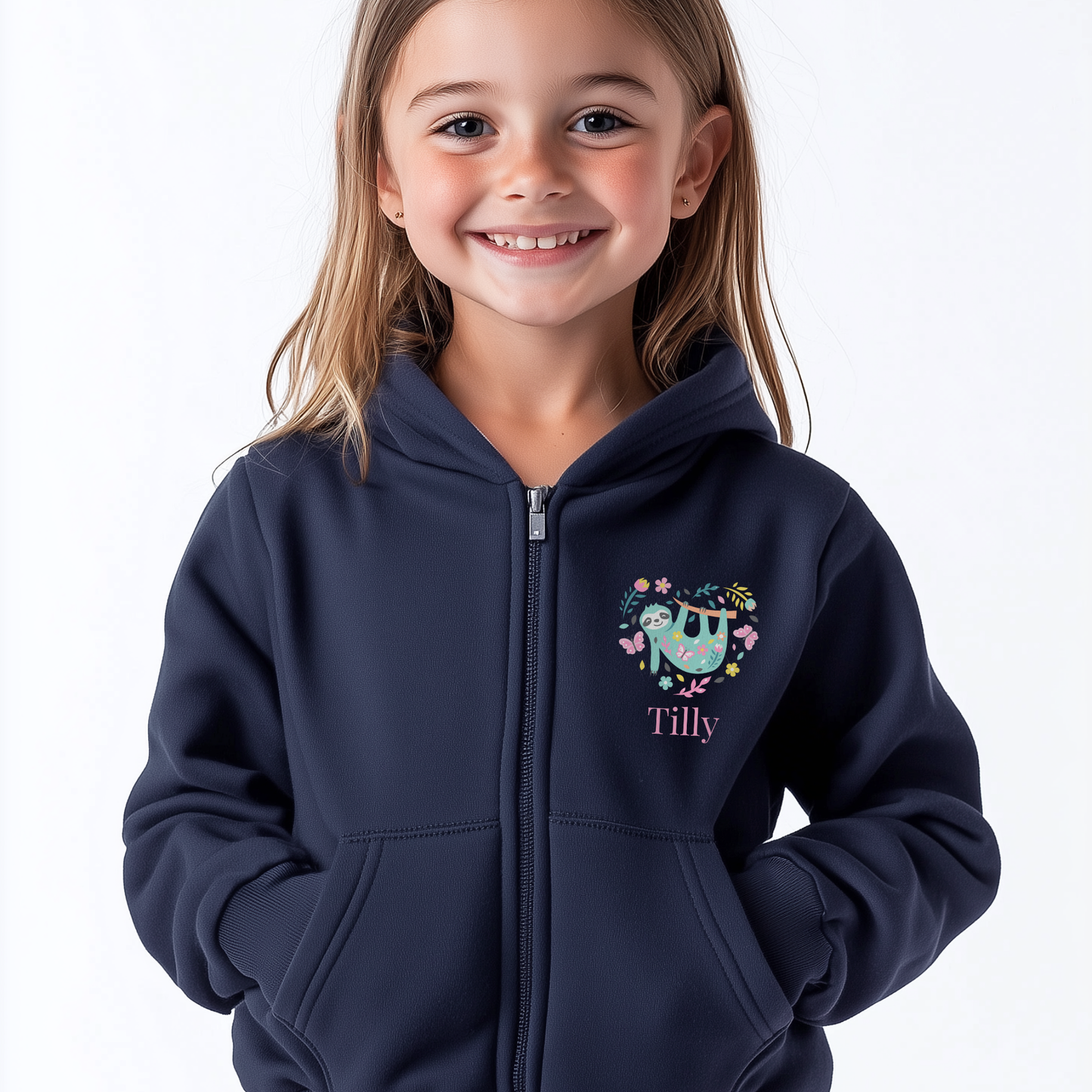 Young girl wearing a navy zip hoodie with cute sloth surrounded by flowers and butterflies forming a heart shape, personalised with child’s name.