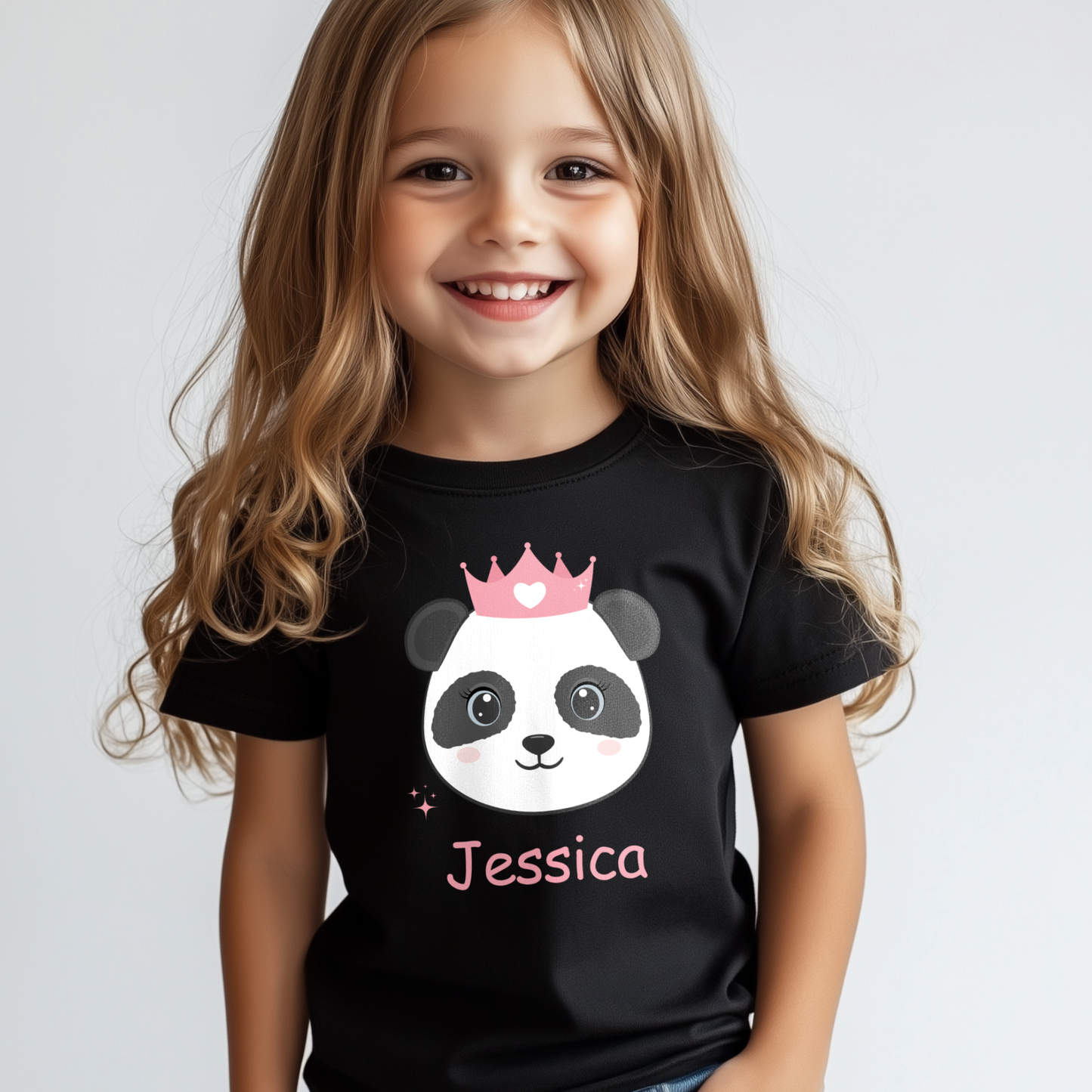 Smiling young girl wearing a black personalised panda princess t-shirt with pink crown and custom name