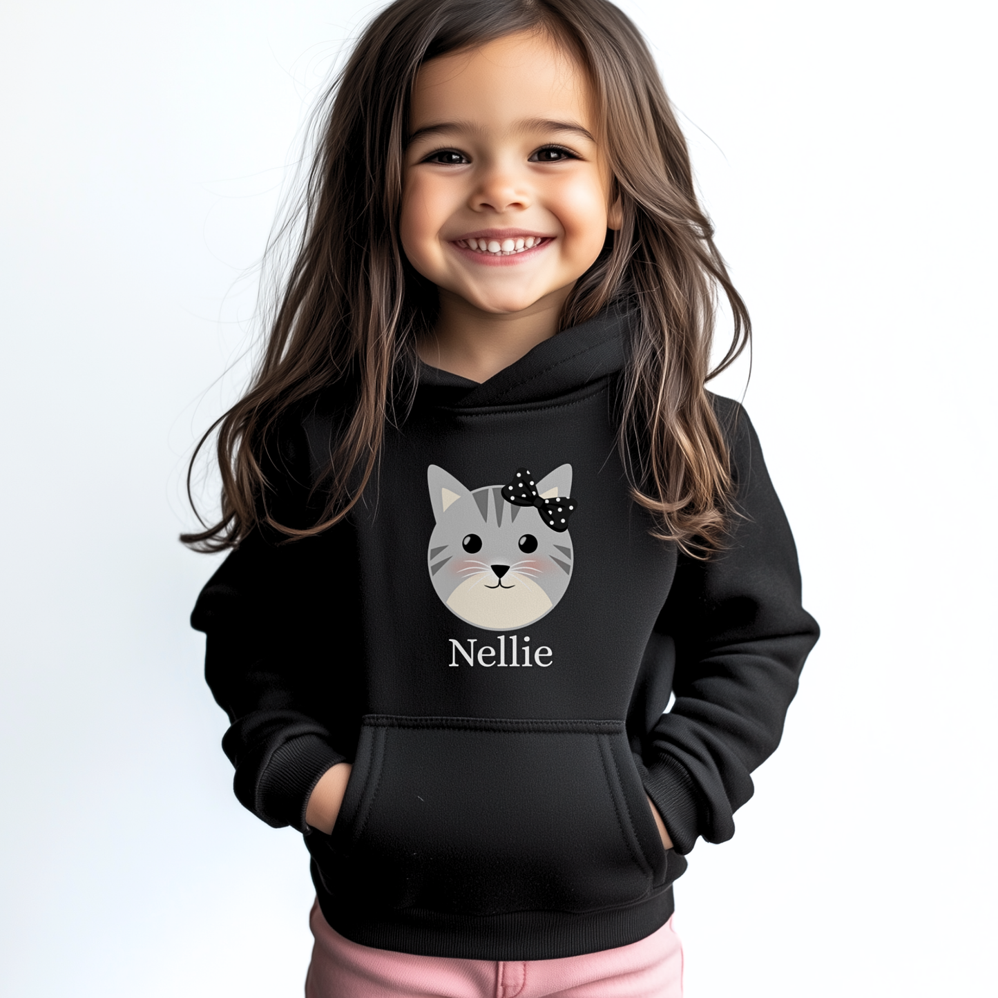 Little girl wearing personalised black cat hoodie with custom name ‘Nellie’ printed under a grey kitten face and black polka-dot bow