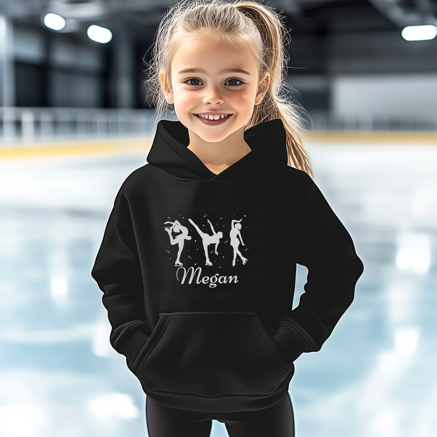 Young girl wearing a black hoodie with dance illustrations and the name 'Megan' at an indoor sports facility.