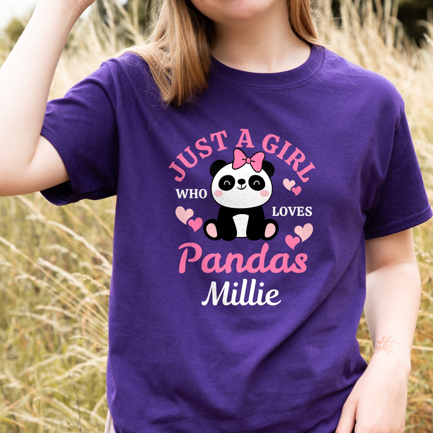 Girl wearing a purple T-shirt with cute panda illustration, hearts and the slogan Just a Girl Who Loves Pandas, personalised with the name Millie.