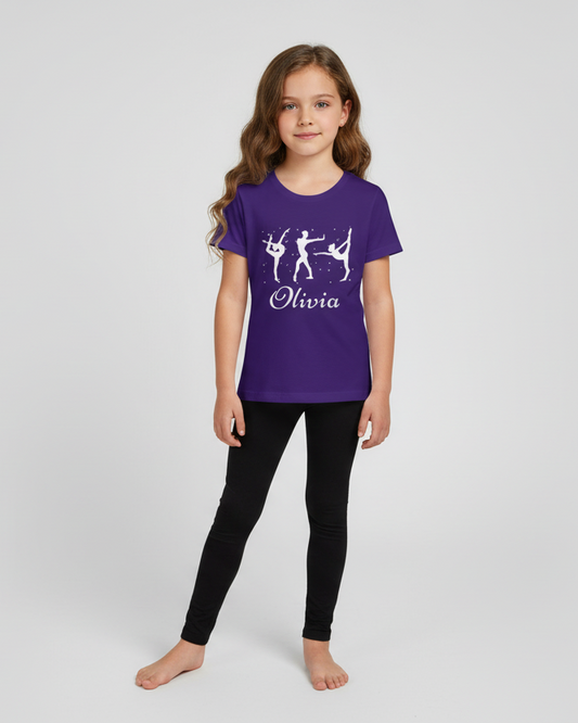 Studio photo of a girl wearing a personalised purple gymnastics t-shirt with white silhouettes and “Olivia” name, paired with black leggings.