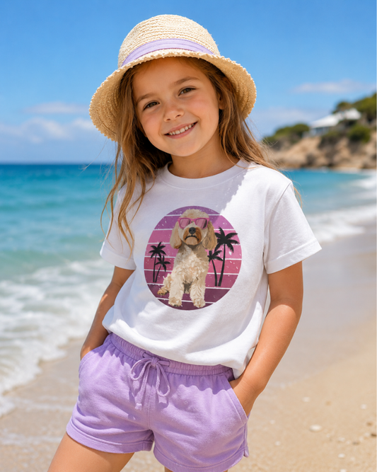 Girl wearing kids Cockapoo with sunglasses dog white cotton t-shirt at the beach