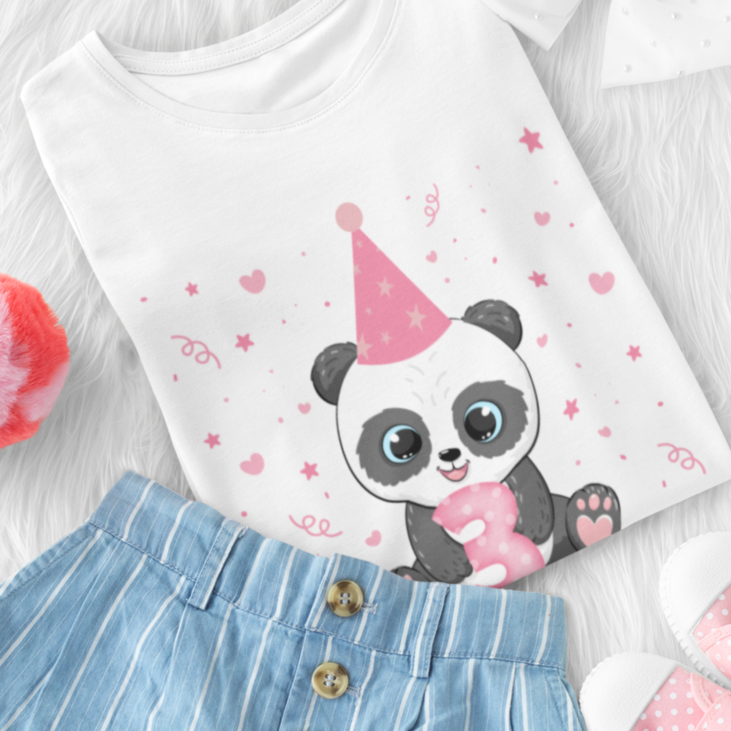 Girls white short sleeve birthday t-shirt featuring a cute panda in a pink party hat holding a pink number 3 with stars and hearts around. Styled with denim shorts and pink pumps.